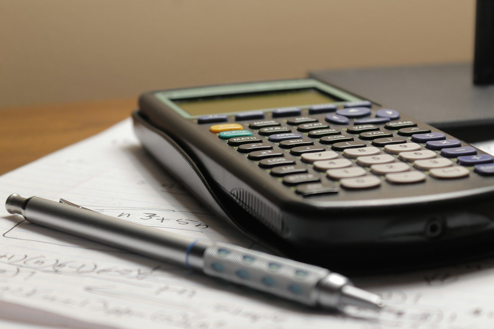 Calculator and pen resting on a sheet of paperwork