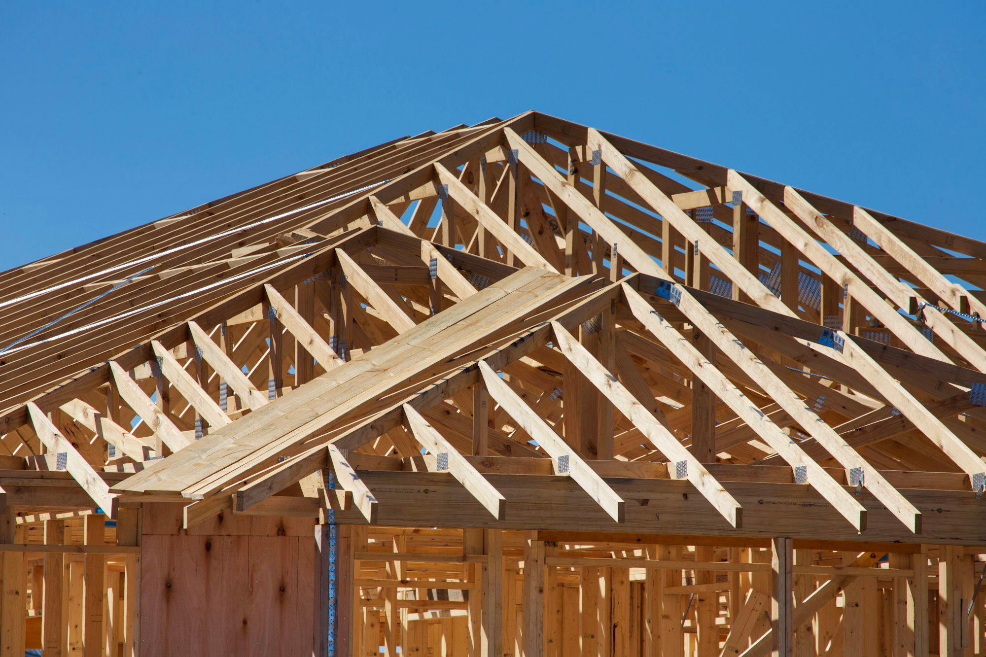 Timber wall framing and roof trusses on a new house under construction